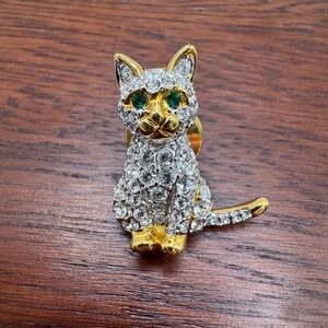 Vintage Swarovski pave crystal cat pin with green eyes.